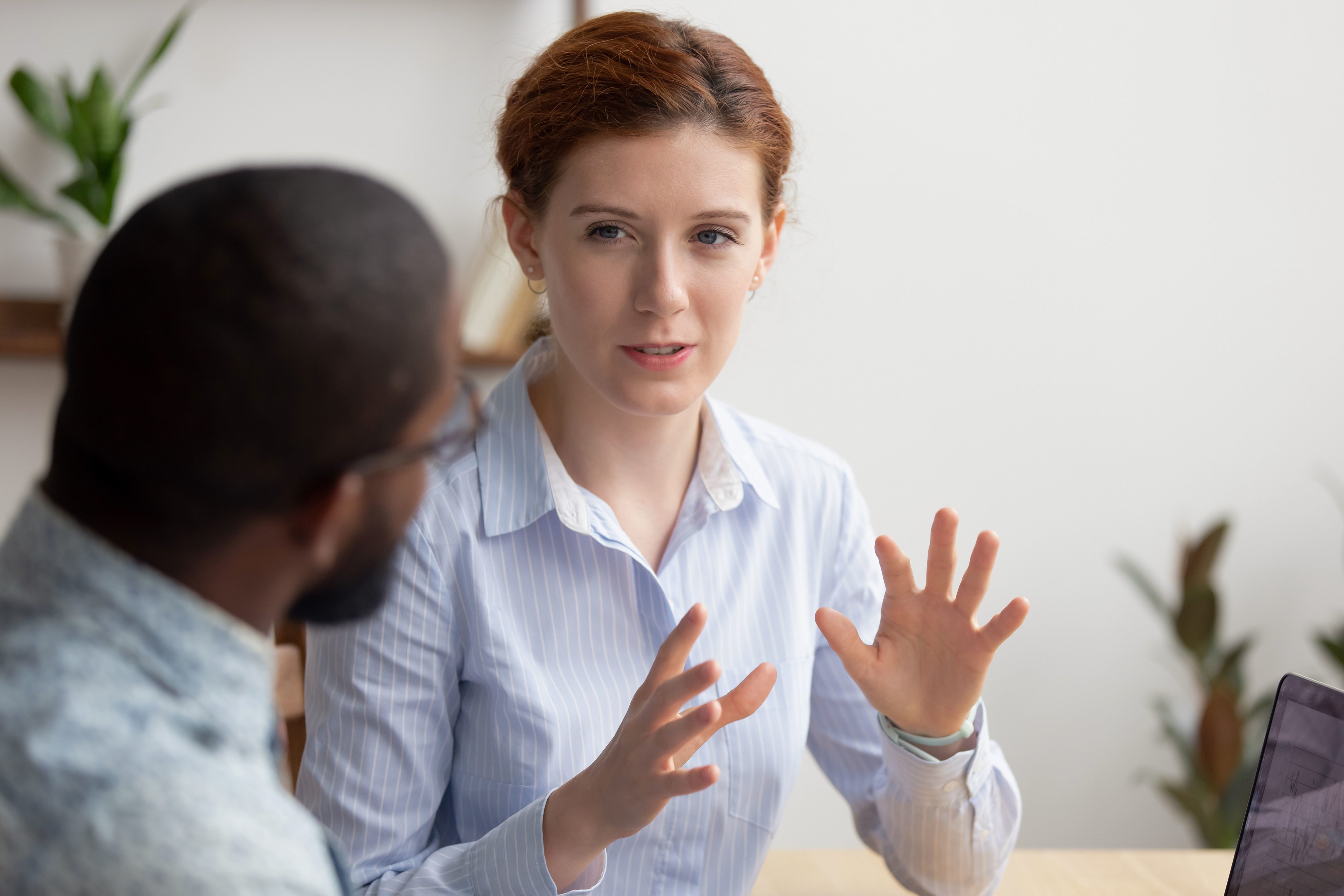 Caucasian businesswoman coach mentor consulting african client intern
